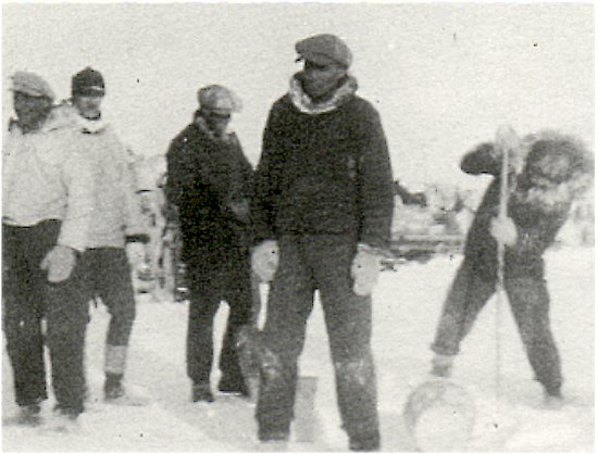 Cutting a hole in the ice, in order to water the team of horses.