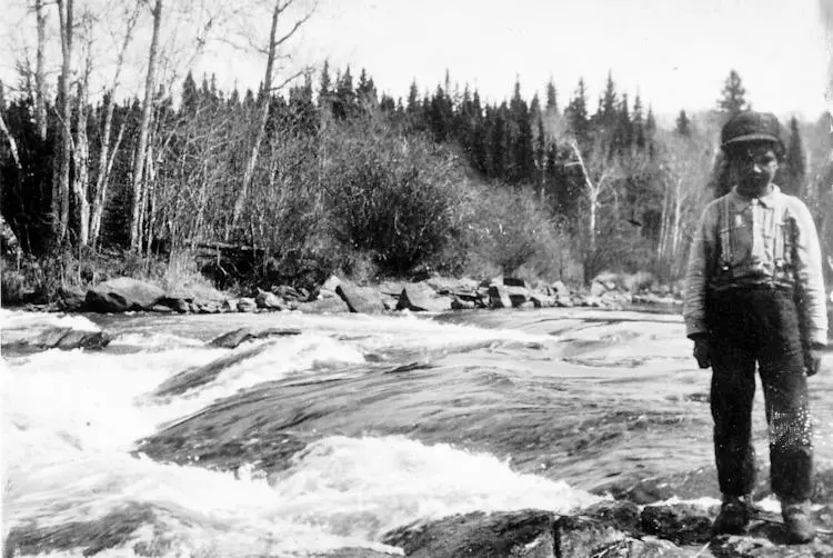 Young Indian boy by the Crow River.