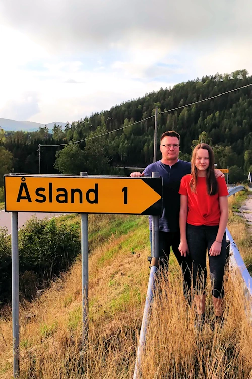 Erik Ausland and his daughter Anastasia at Asland Farm sign.