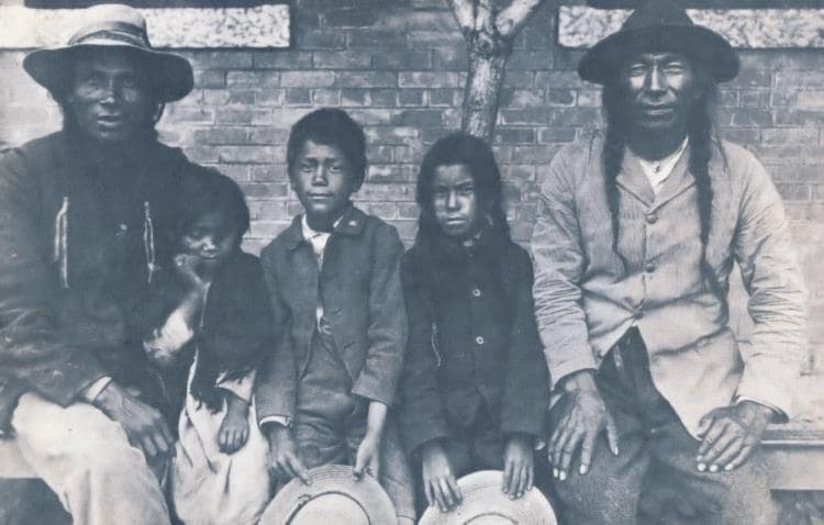 Indian children with their fathers arriving at school, 1904.